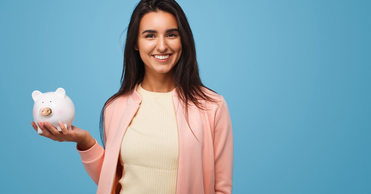 young woman holding a piggy bank