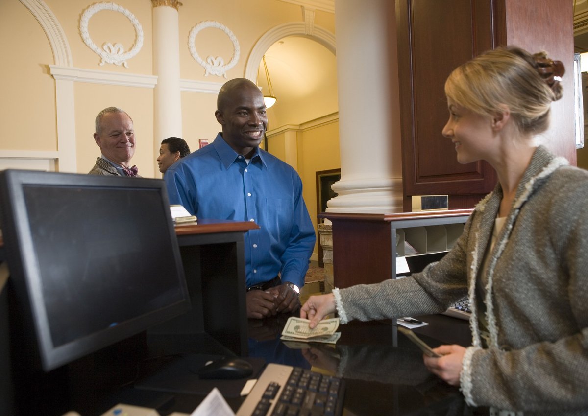 A bank teller assisting a customer with cash transactions.