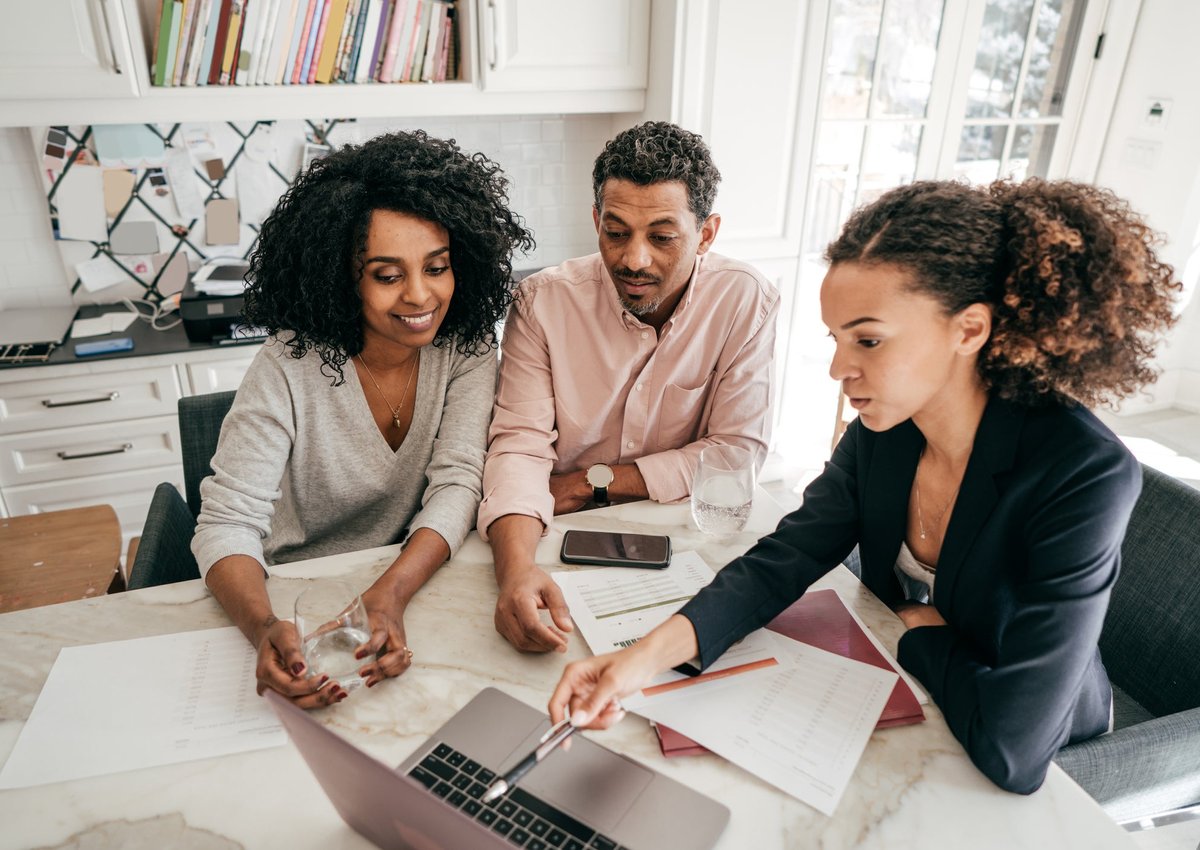 A couple go over their personal finances with a lender.
