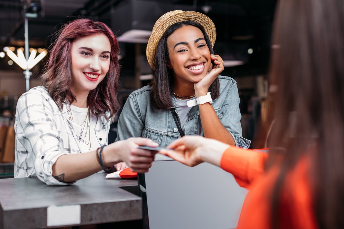 Two people paying for something with a credit card