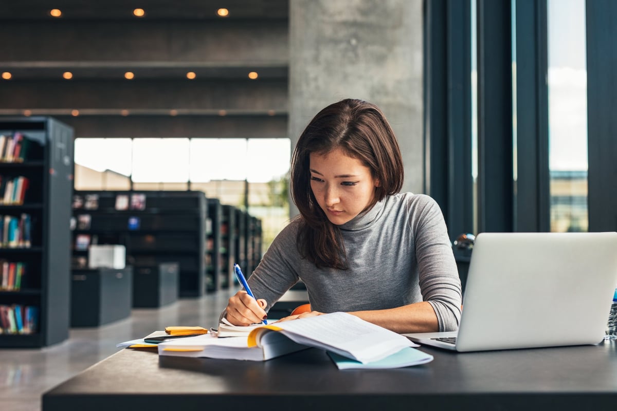 A female college student studying in the library.
