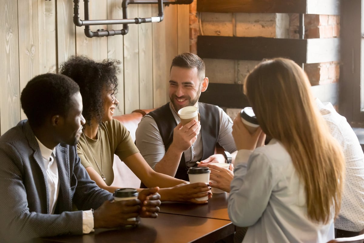 Smiling friends having coffee in a cafe.