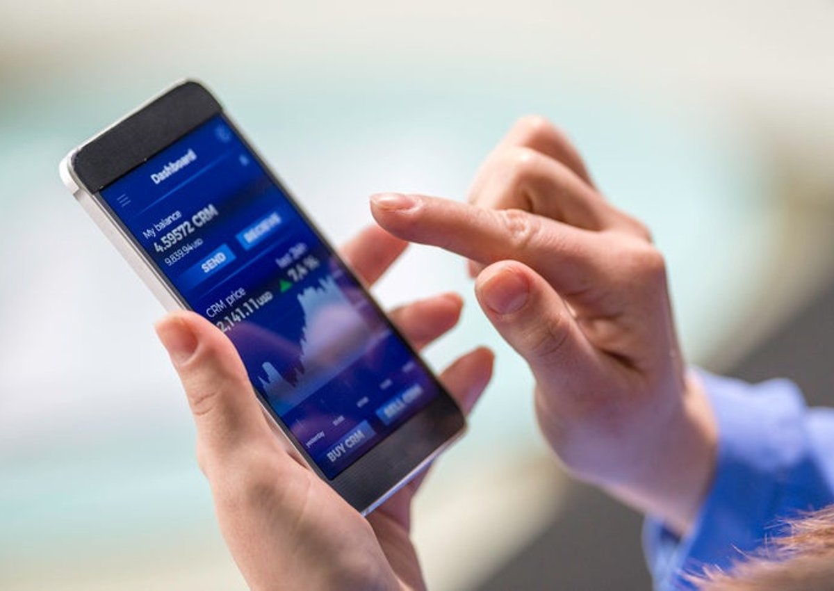 A woman buys cryptocurrency through a mobile phone app.