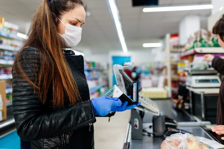 Woman at checkout ready to pay for groceries with credit card.jpg