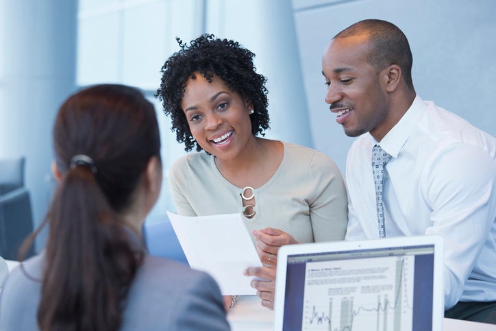 A couple discusses their finances with a bank associate.