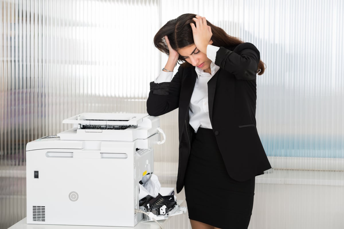 Business man is frustrated with the office printer