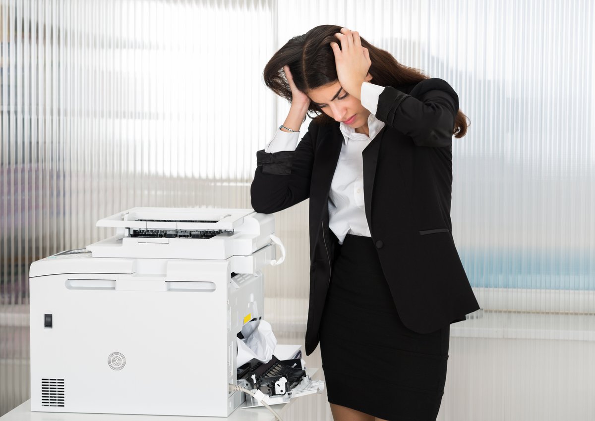 business person annoyed at office printer