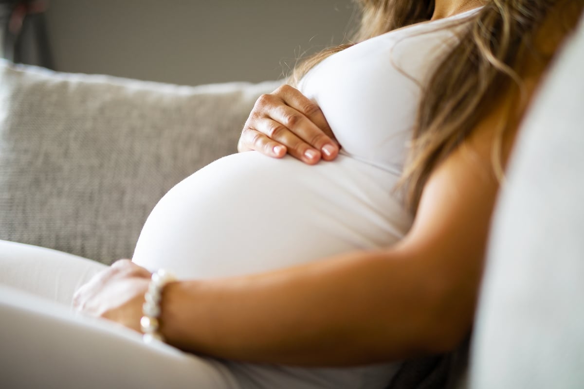 woman touching her pregnant belly