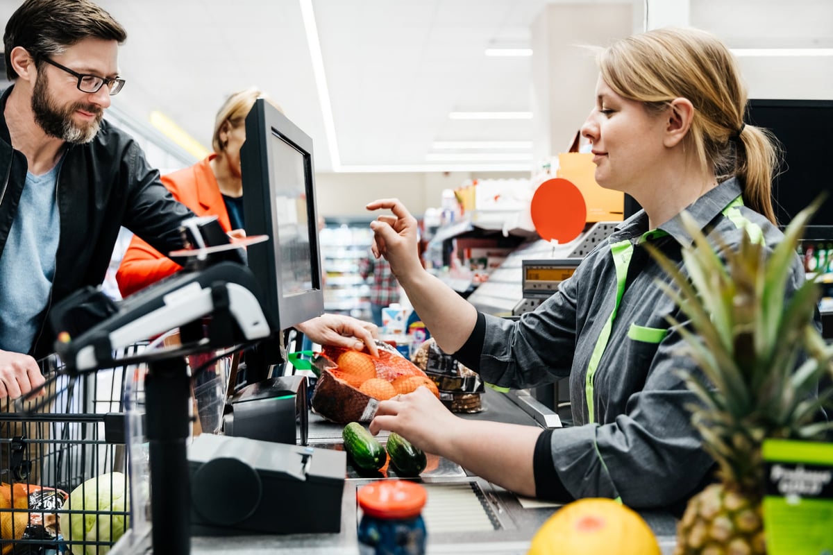 Grocery store employee calling customer