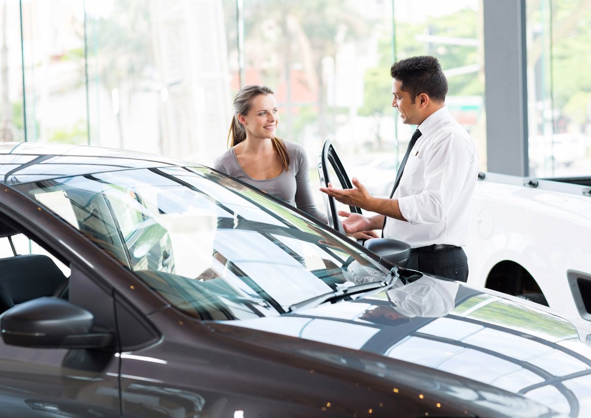 Dealer Showing Female Customer A Car