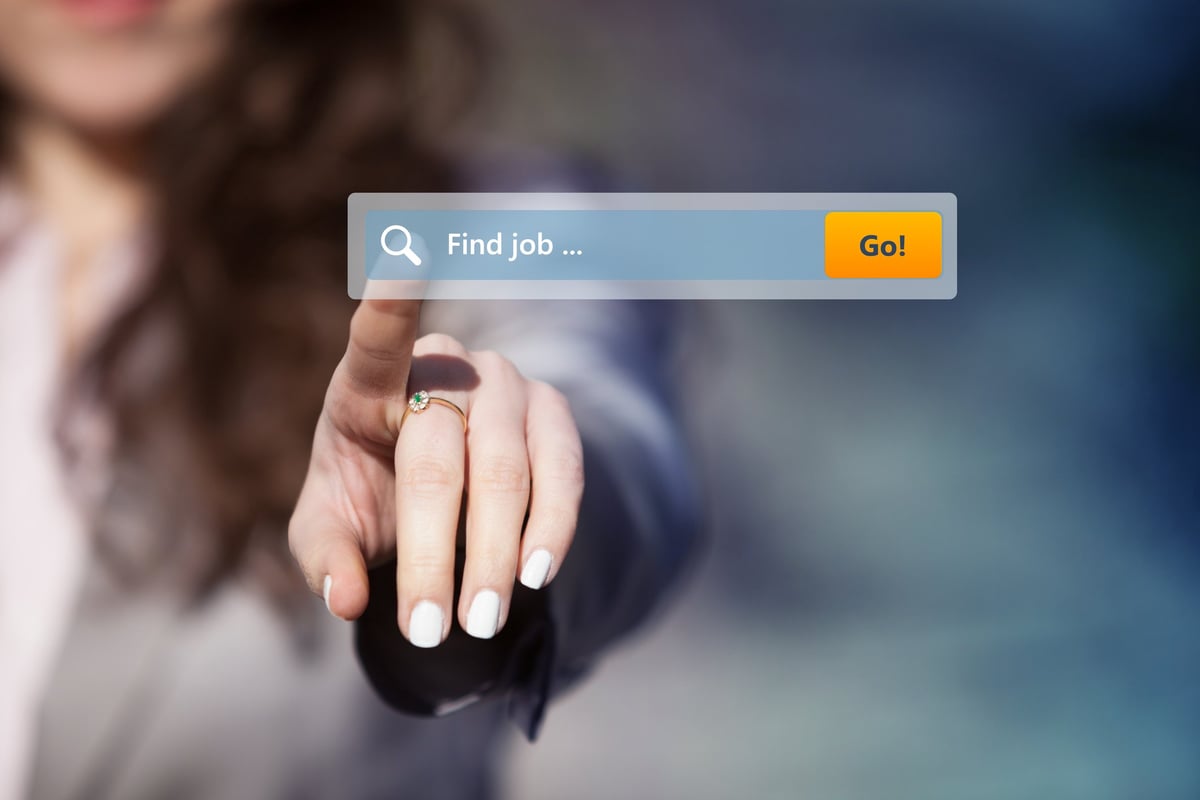 Woman pointing at Internet search box labeled "Find job"