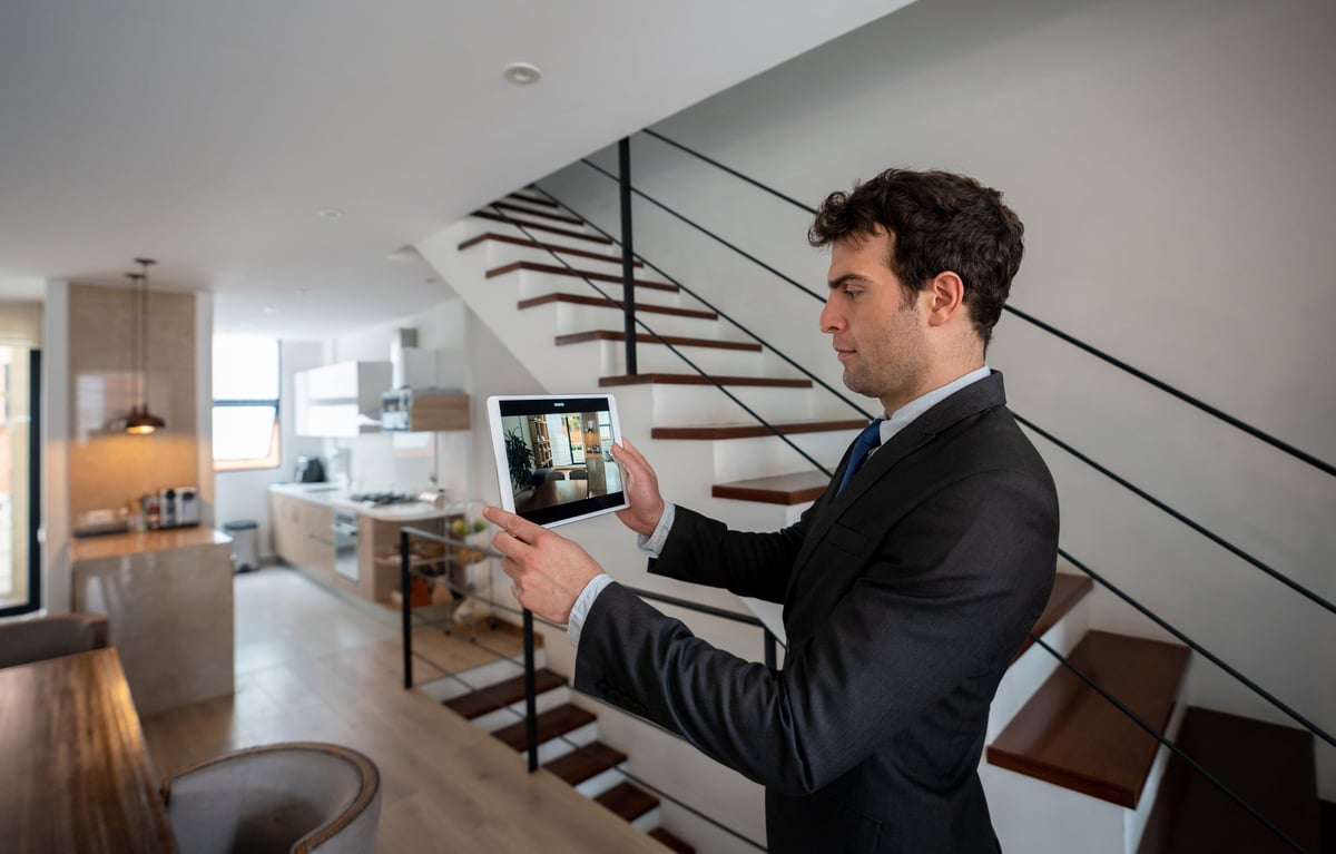 Man holding a tablet doing a virtual home tour.