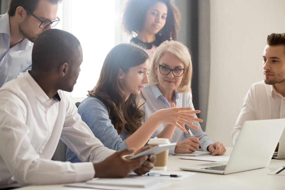 A team office meeting being led my a female manager.