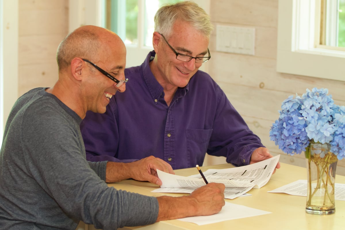 An older couple sit and go over their finances.