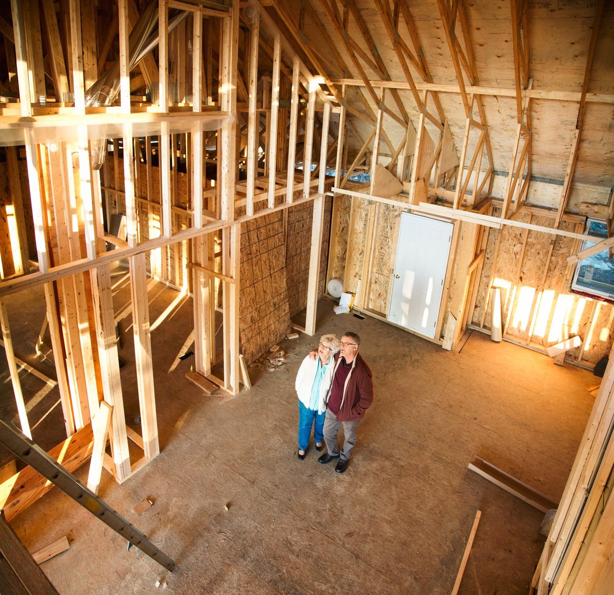 An older couple admire the inside of their unfinished home.