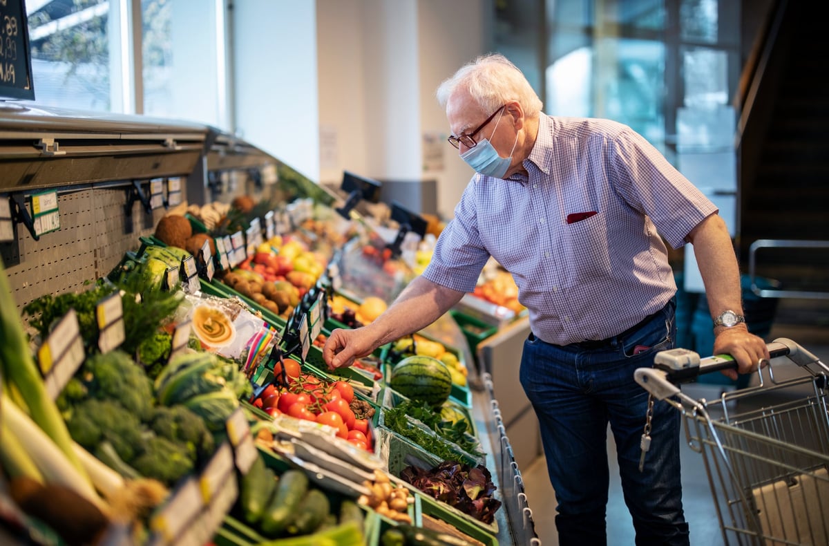 An older man shops at a grocery store.