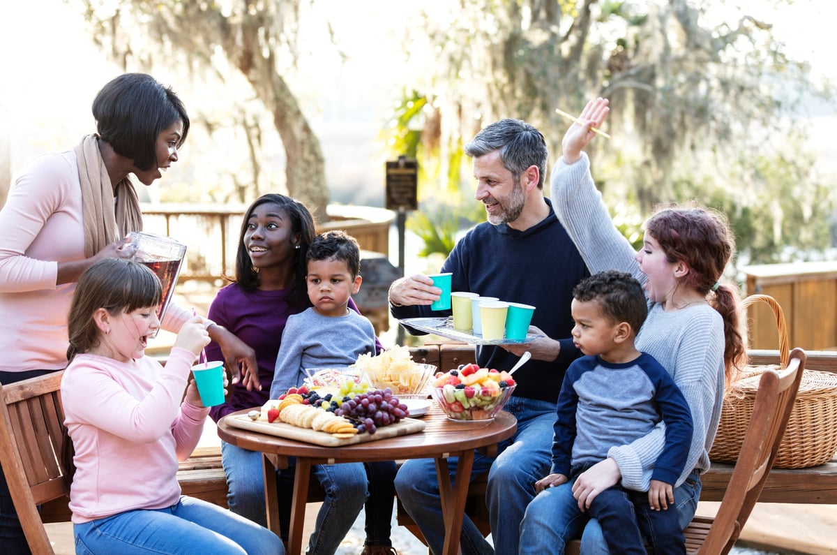 Parents having a picnic with five children.