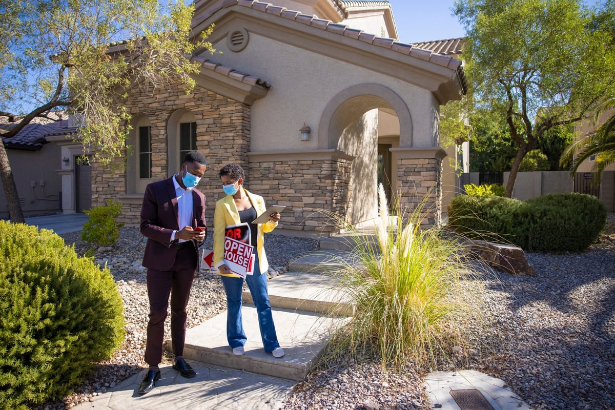 Real estate agent preparing house for Open House with signs.