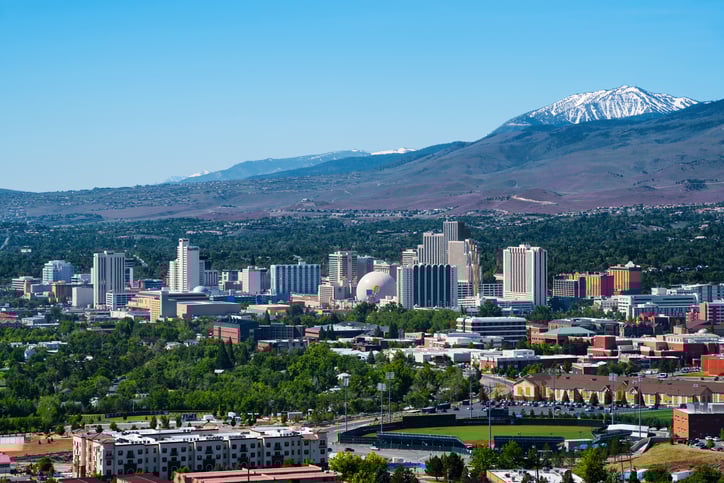 An aerial view of Reno, Nevada, with mountains in the background.