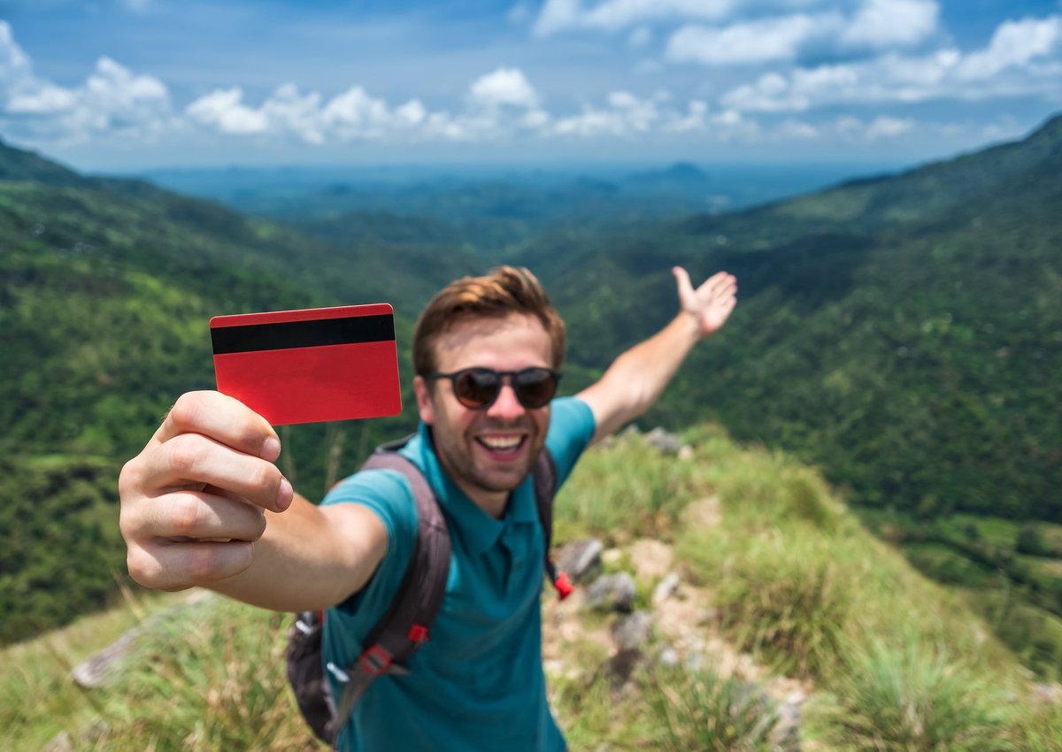 Traveler with credit card in mountains