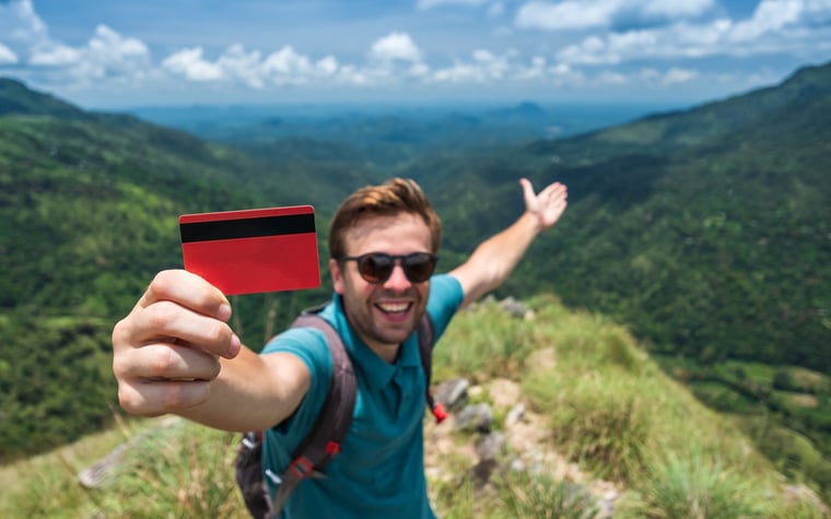 Traveler with credit card in mountains