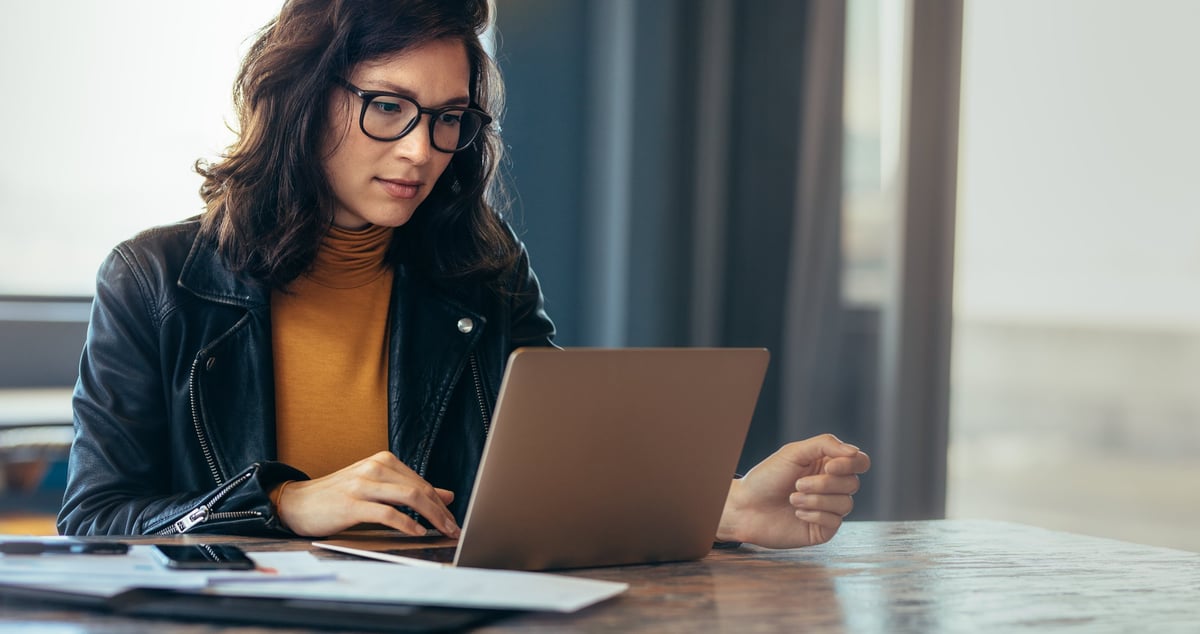 Woman working on a laptop.