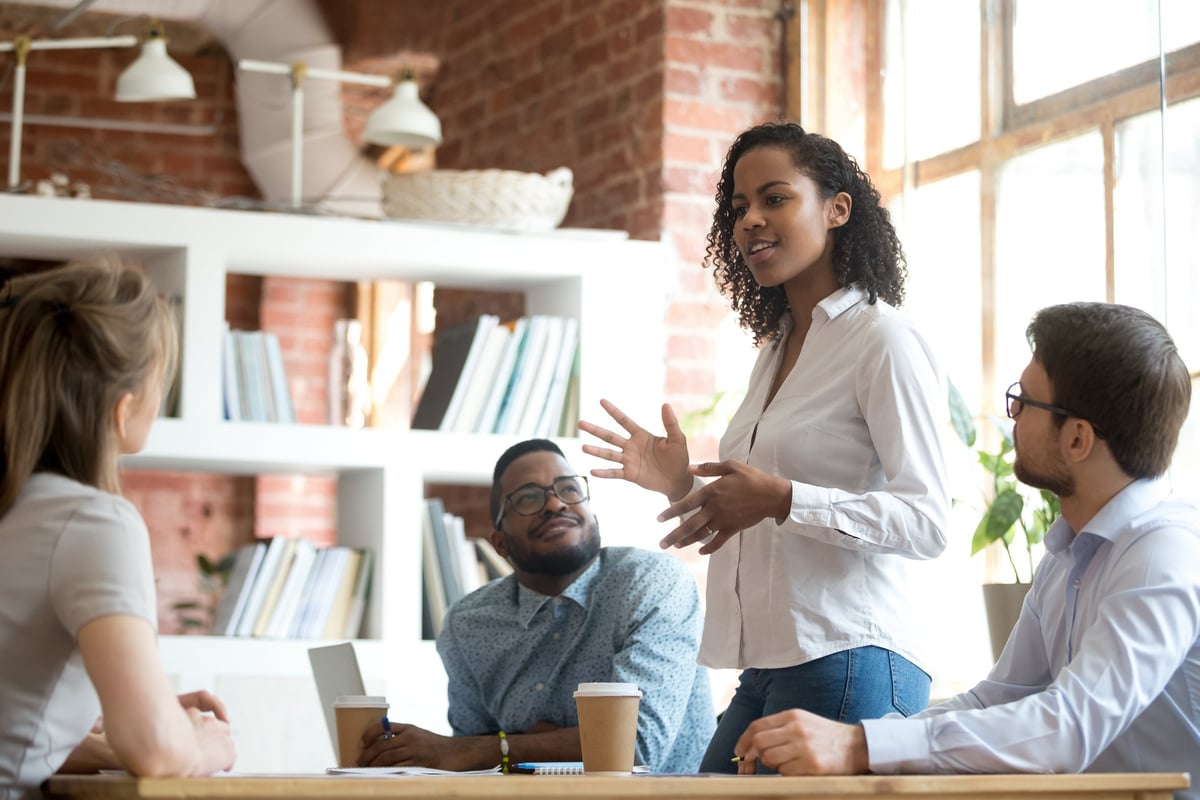 A woman chairs a meeting in an office.