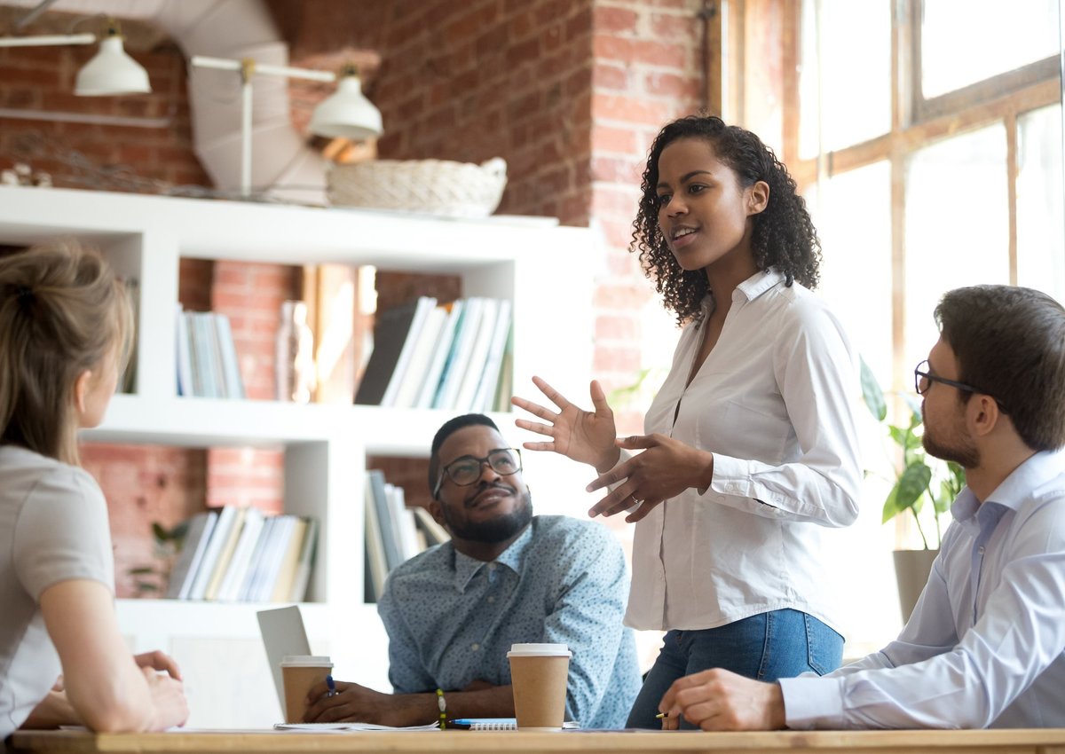 A woman leading a meeting in an office.