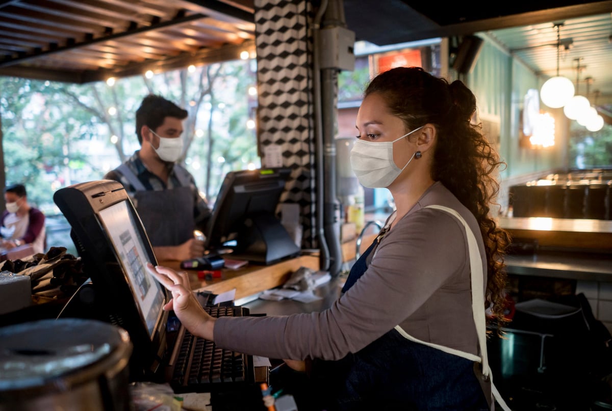 Woman working as cashier in restaurant