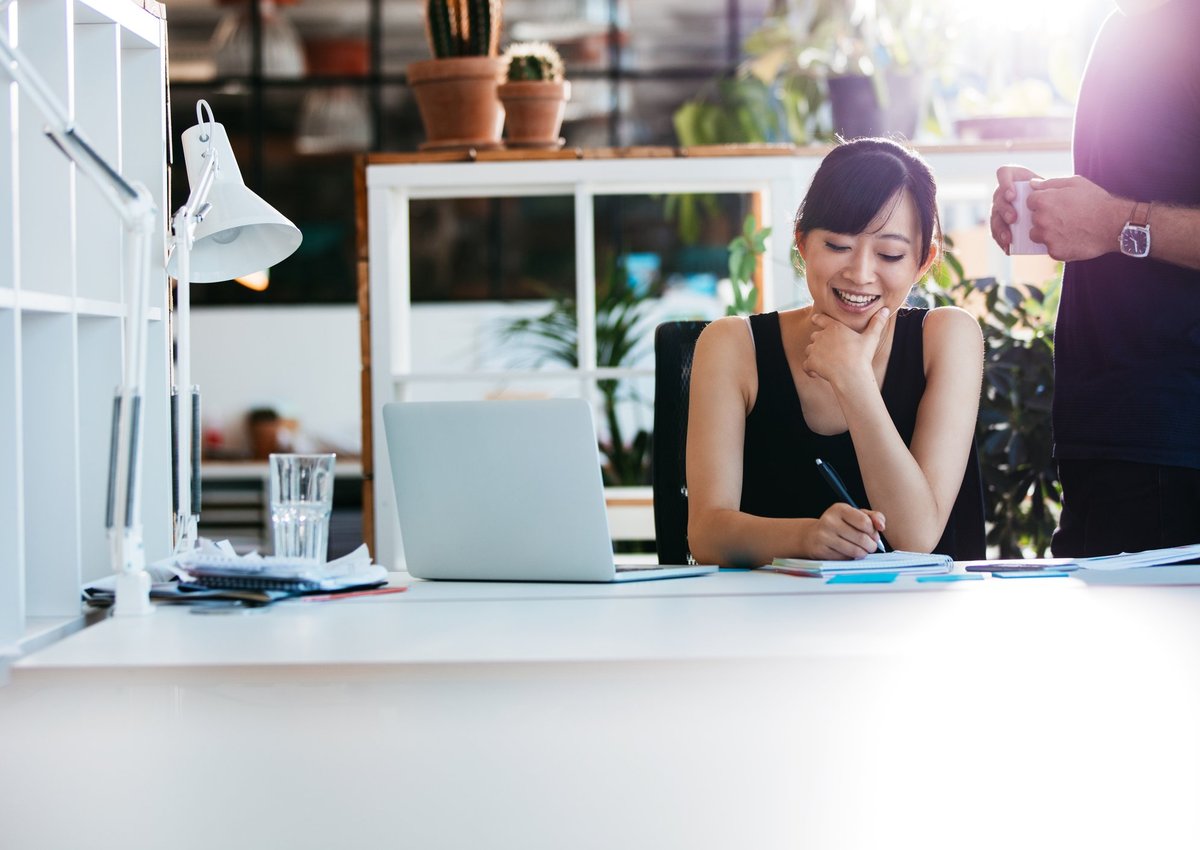 Smiling woman working in a bright office.