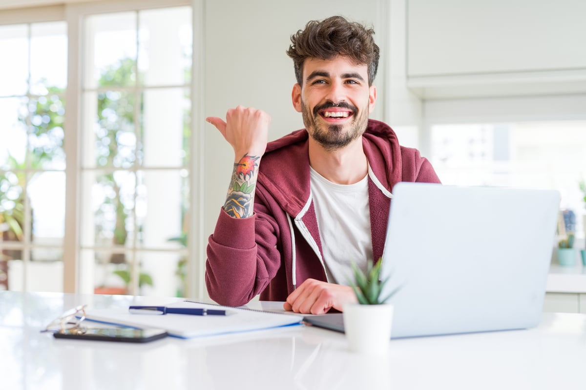 Young Man With Books And Laptop