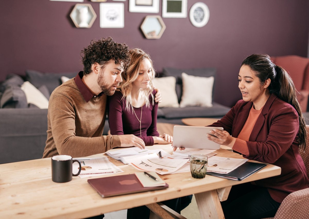 Young couple meets with professional woman.
