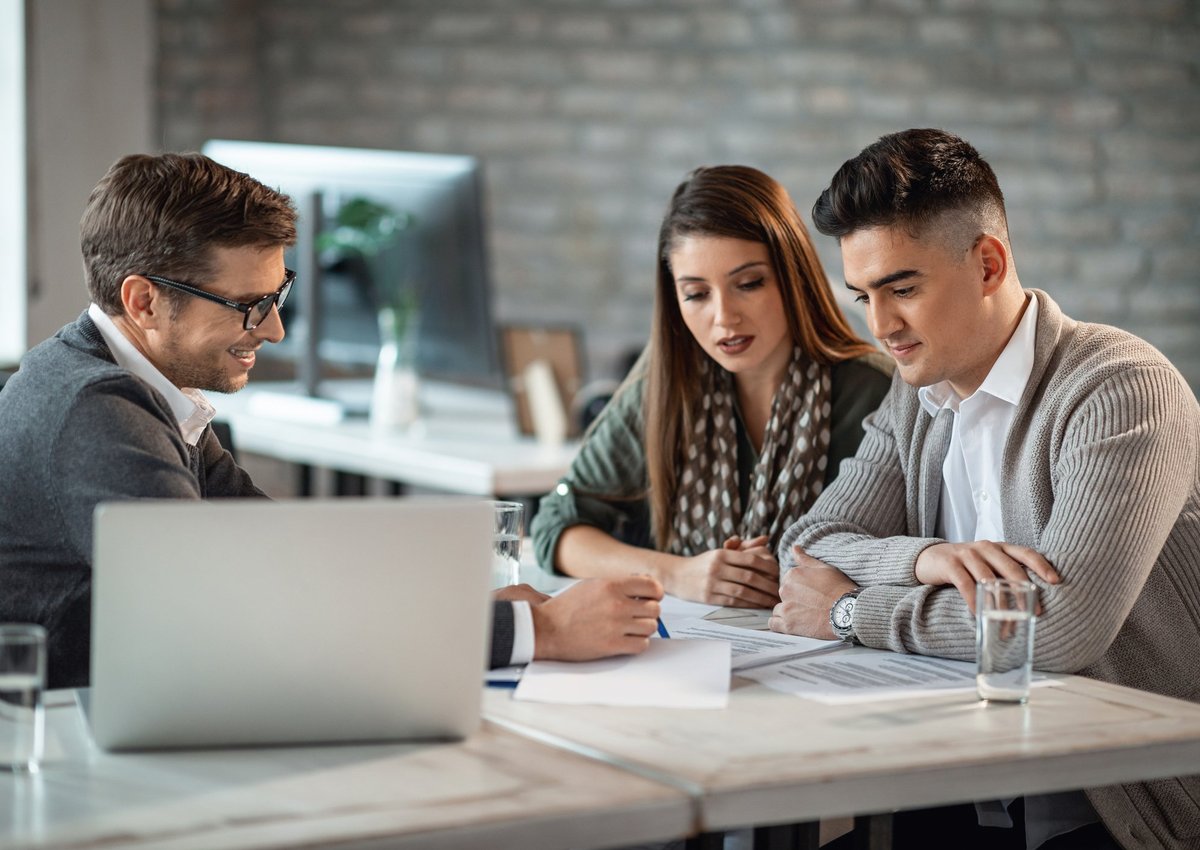 A young couple meeting with a financial advisor.