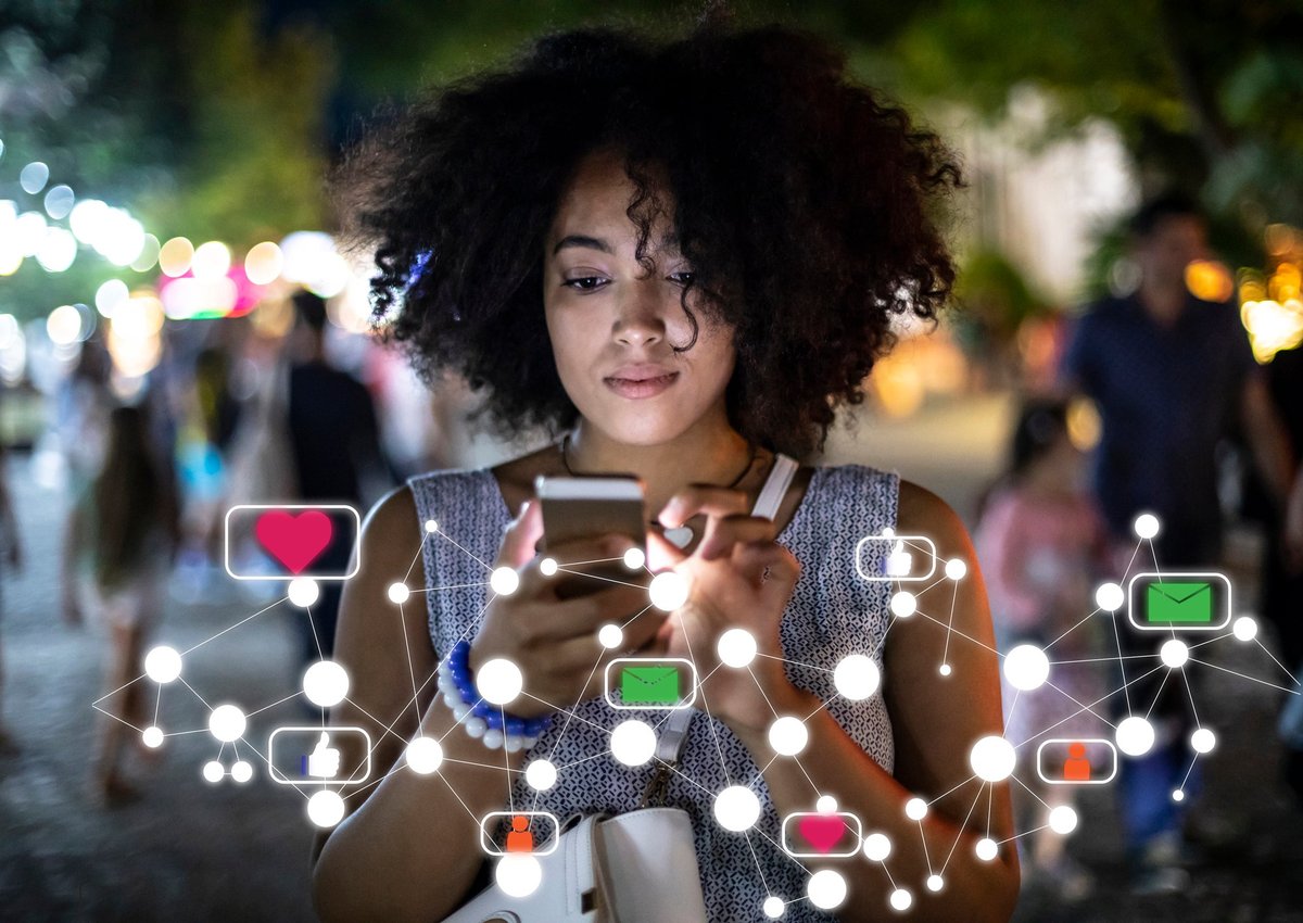 A young woman uses her phone to explore social media.