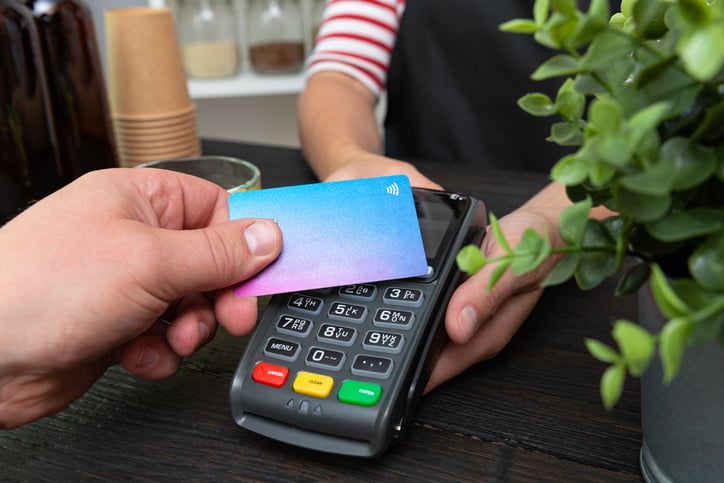 Someone pays with a contactless credit card.