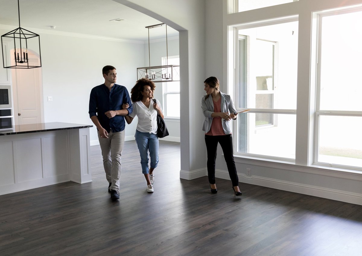 A couple meet with their realtor to look at a home.