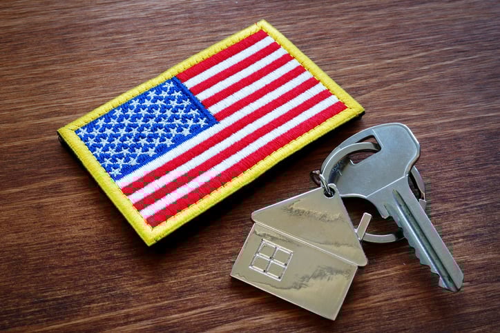A flag patch and house key on a table