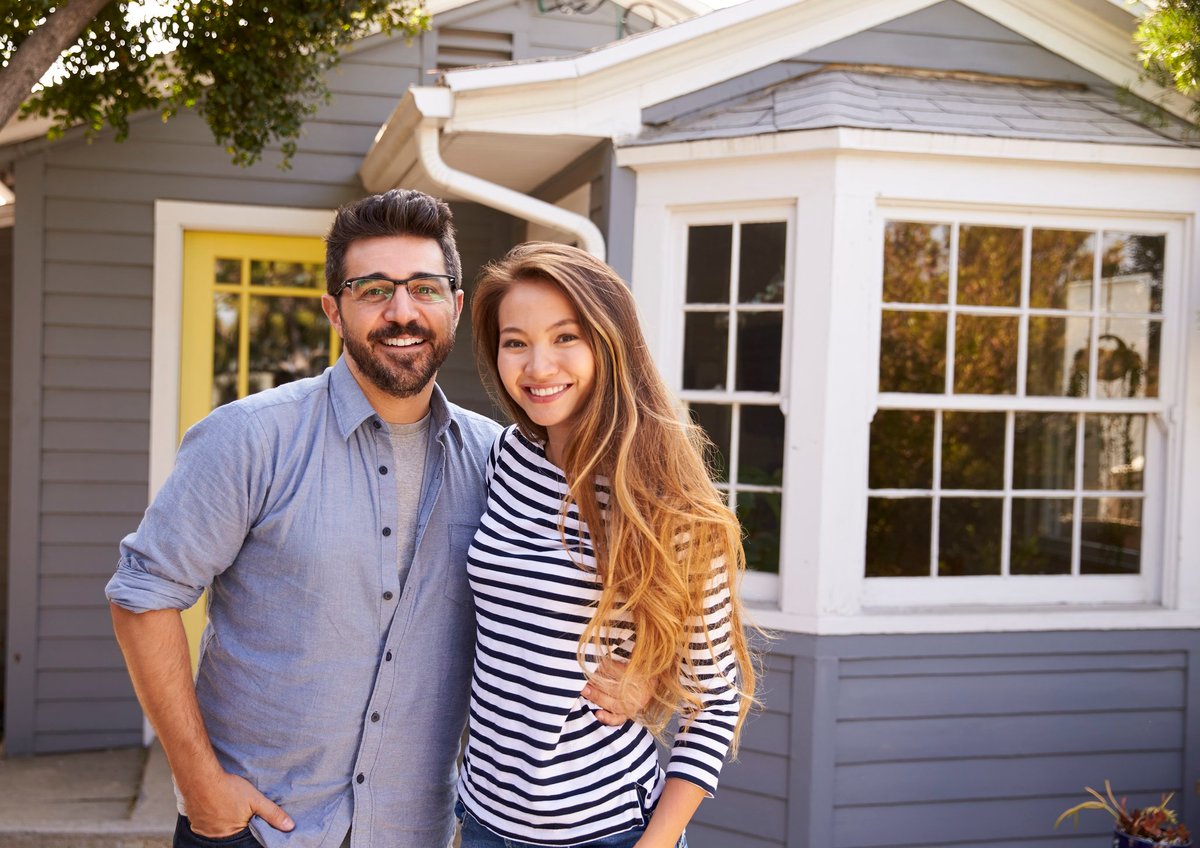 Home with a couple standing in front of it