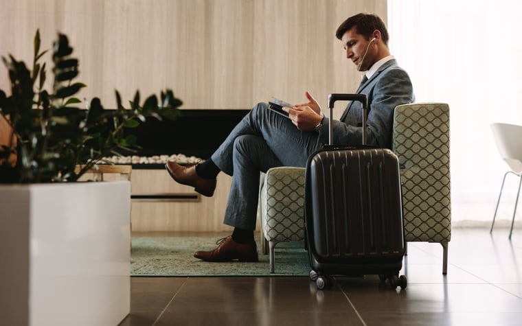 man relaxing in airport lounge