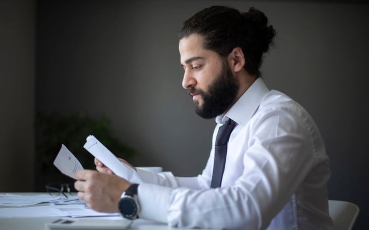 A man looking at his bills.