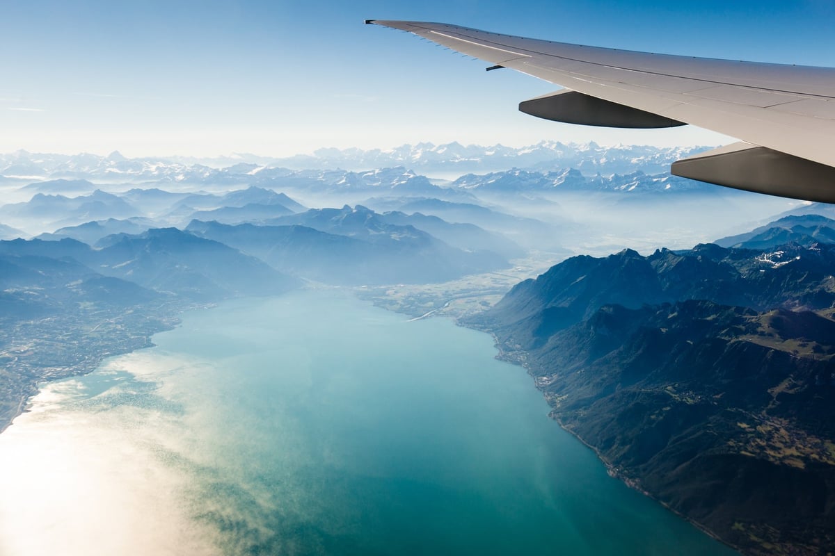 plane wing over hills and water