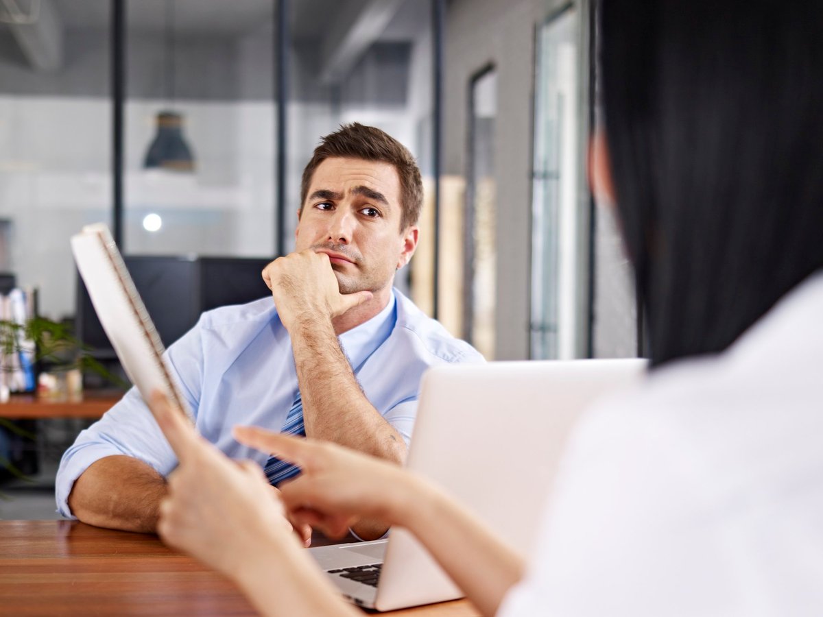 interviewer looking at interviewee with raised eyebrow.