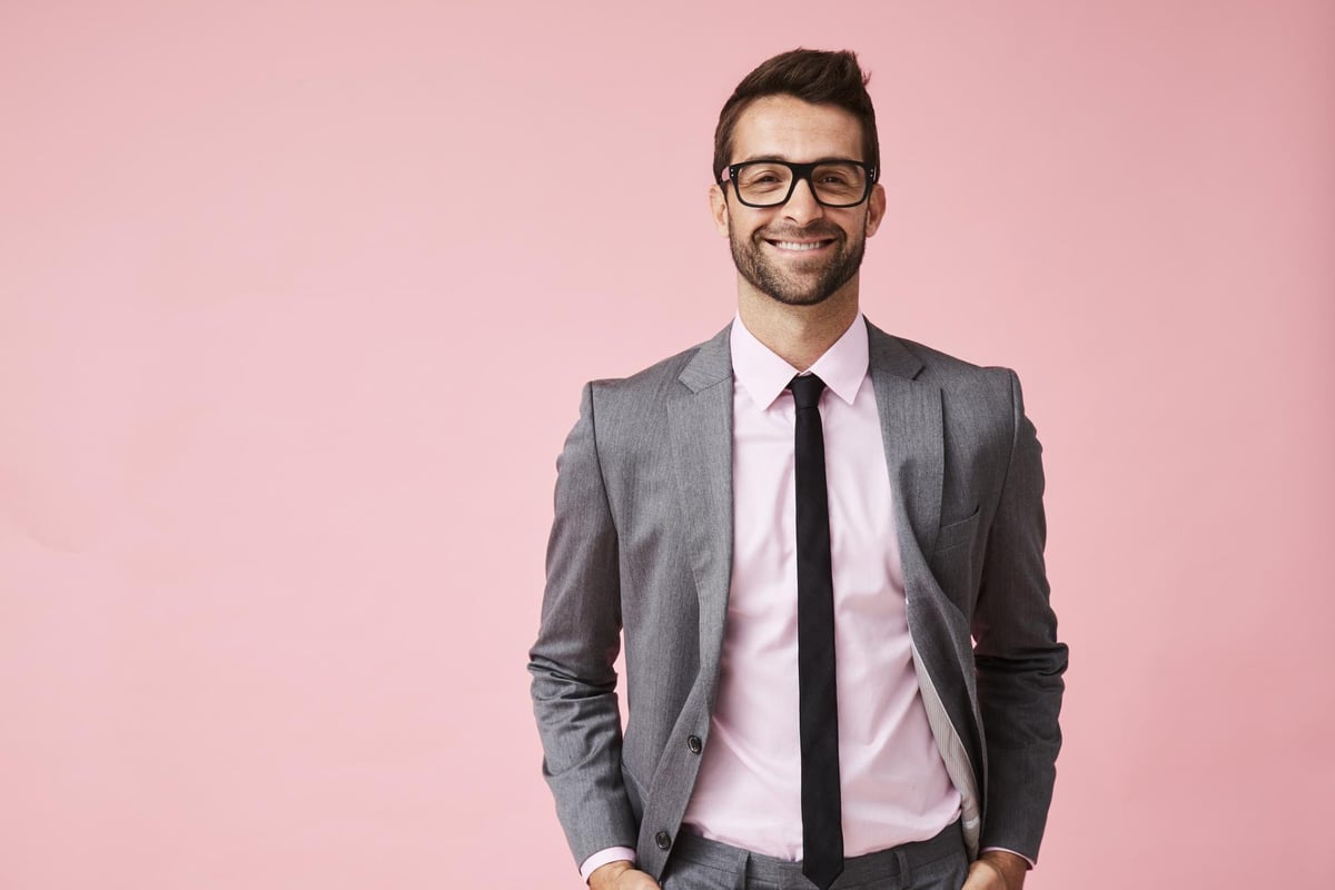smiling young man in suit and glasses