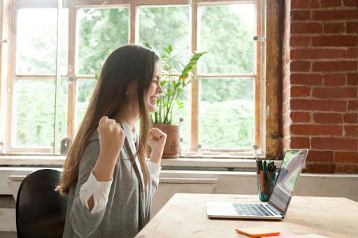 Lady at Laptop Celebrating