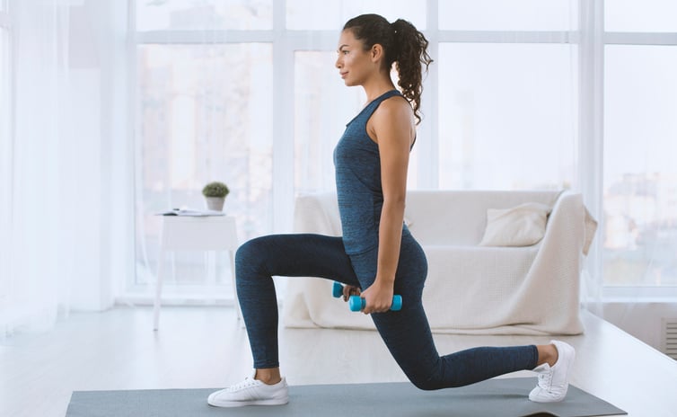A woman exercising in her living room.