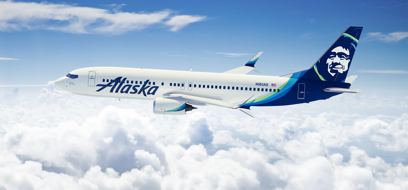 An Alaska Air plane in the sky.