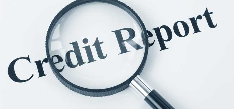 A magnifying glass over the words Credit Report.