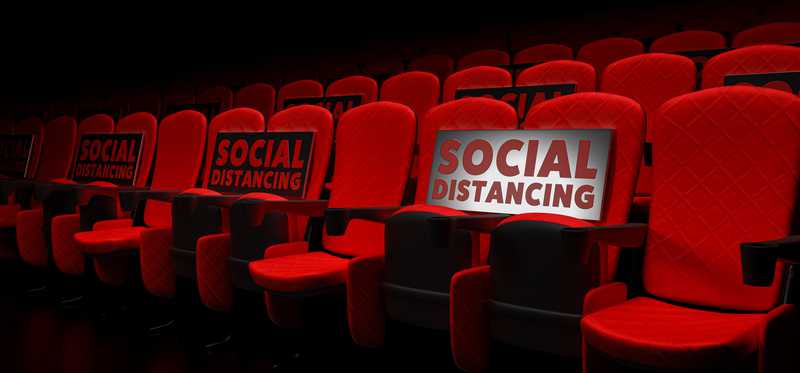 Theater seats with Social Distancing signs on them