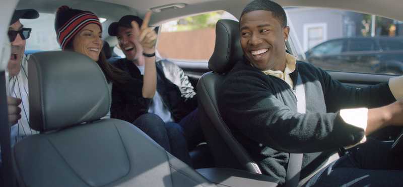 Uber driver driving three passengers in vehicle.