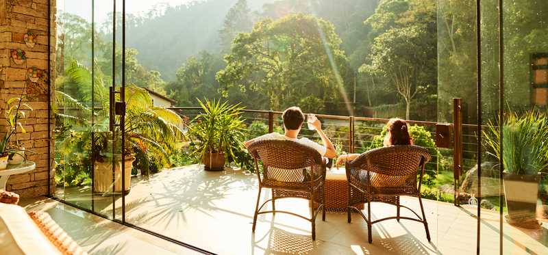 A view overlooking an exotic jungle scene from a luxury hotel window.